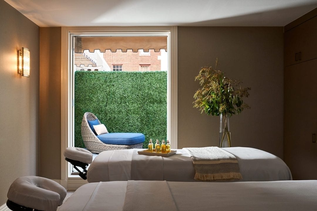 Massage room with tables and outdoor area and lounge chair