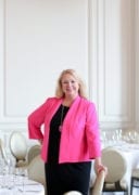 Woman standing in a reception room, posing for camera