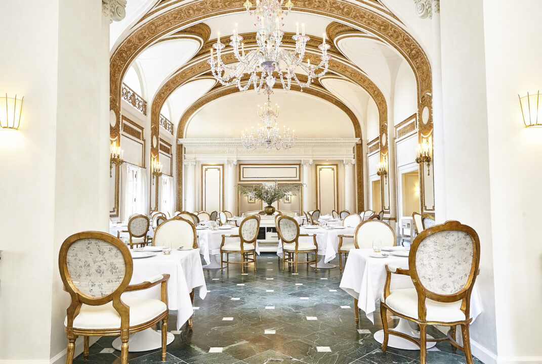 the french room dining room and large chandeliers hanging from arched ceilings