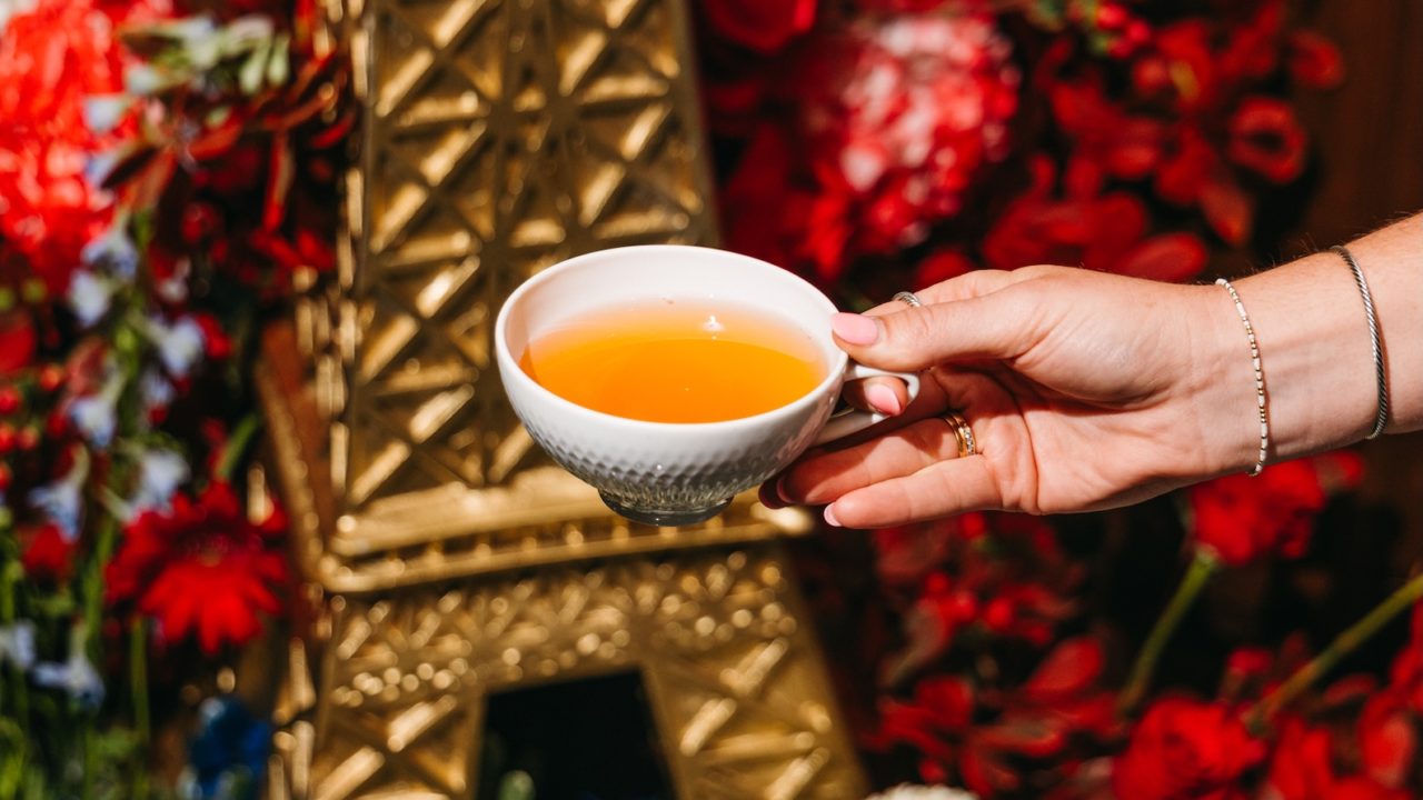 Cup of tea in front of an Eiffel Tower display