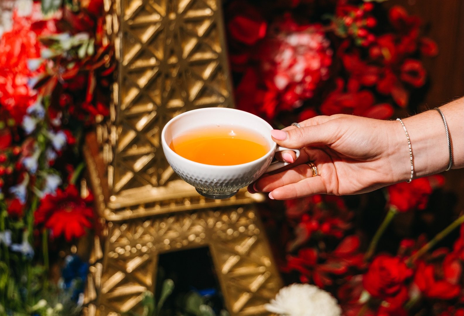 Cup of tea in front of an Eiffel Tower display
